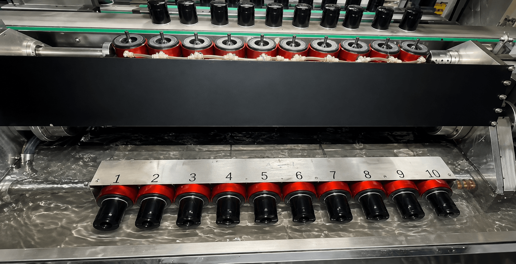 Multiple oil filter components undergoing production quality testing